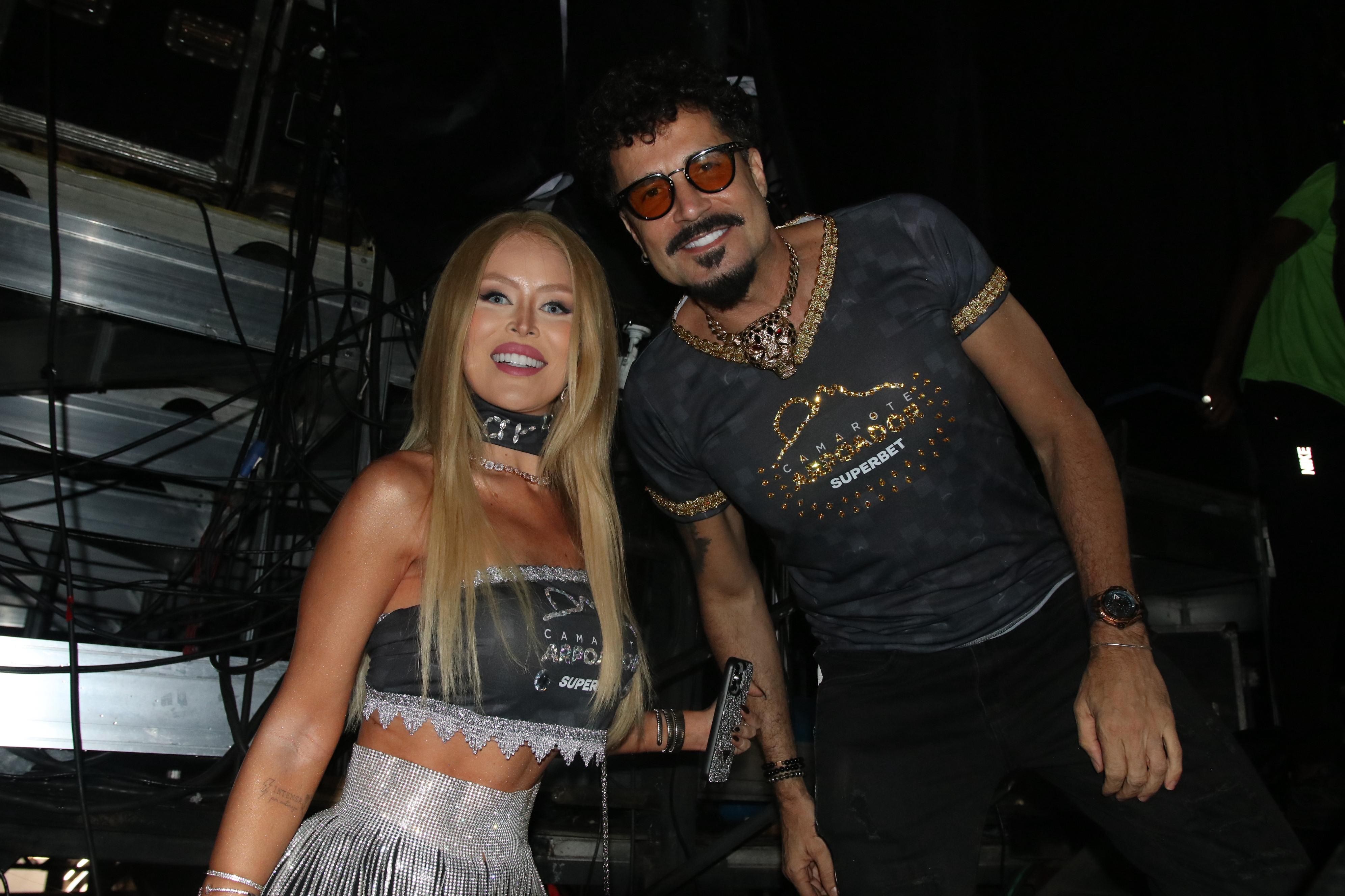 Exibindo novo visual, Latino vai a camarote com noiva